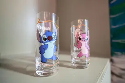 two clear glass vases with cartoon characters on them at Surf and Sun Stitch Studio Kissimmee in Kissimmee