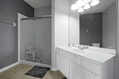 a white bathroom with a sink and a shower at Vista Cay Resort Minutes to Parks & Magic! in Orlando
