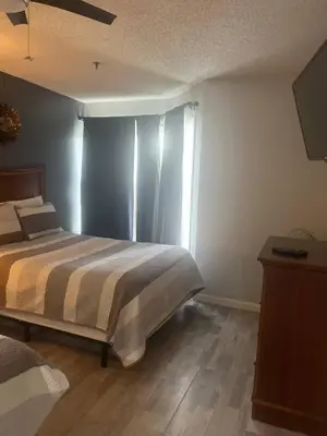 a bedroom with a bed and a window at Condo Near Disney No Resort Fee Free Parking in Orlando