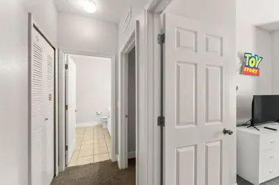 a hallway with a white door and a television at Family 3BR near Disney -4102 in Kissimmee