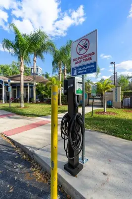 a no smoking parking meter with a sign on a street at Family 3BR near Disney -4102 in Kissimmee