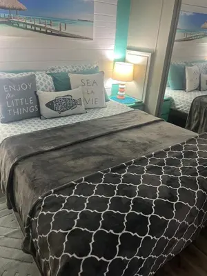 a bedroom with a large bed with pillows at Cozy Private Cottage Only 5 miles from Disney in Kissimmee