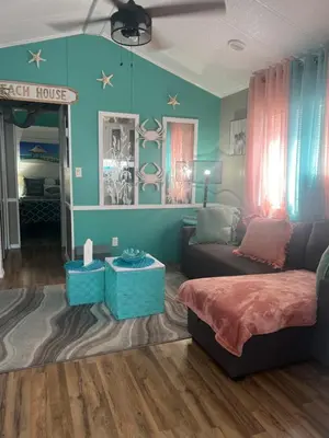 a living room with a couch and a table at Cozy Private Cottage Only 5 miles from Disney in Kissimmee
