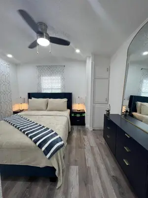 a bedroom with a bed and a ceiling fan at Luxury Tiny Cottage 5 miles from Disney in Kissimmee