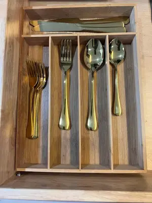 four gold forks and spoons in a wooden drawer at Luxury Tiny Cottage 5 miles from Disney in Kissimmee