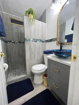 a bathroom with a toilet and a sink at Luxury Tiny Cottage 5 miles from Disney in Kissimmee