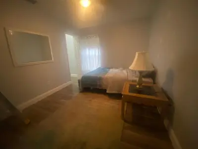 a bedroom with a bed and a lamp on a table at Orlando 4 bedroom Family Retreat in Orlando