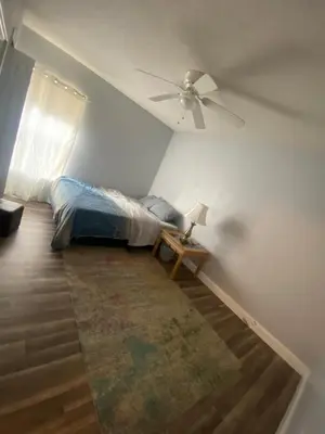 a bedroom with a bed and a ceiling fan at Orlando 4 bedroom Family Retreat in Orlando