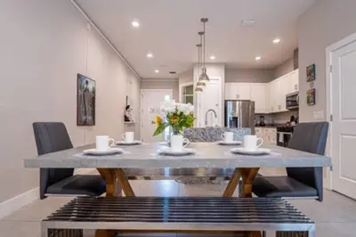 a dining room table and chairs in a kitchen at 4 Luxurious Suites Near Theme Parks and Downtown in Orlando