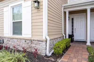a house with a brick walkway leading to the front door at 4 Luxurious Suites Near Theme Parks and Downtown in Orlando