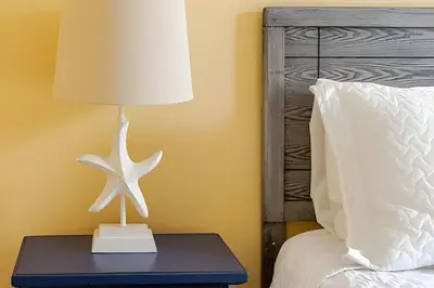 a lamp on a table next to a bed at Excelente Refúgio em Indian Wells c/ Piscina Priv! in Kissimmee