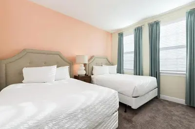 a bedroom with two beds and a window at Luxury 9-Bedroom Villa with Pool Near Disney in Orlando