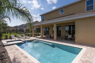 a swimming pool in front of a house at Luxury 9-Bedroom Villa with Pool Near Disney in Orlando
