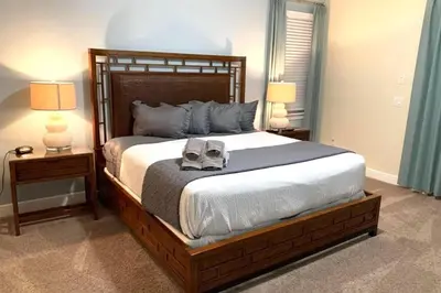 a bedroom with a large bed with shoes on it at Luxury 9-Bedroom Villa with Pool Near Disney in Orlando