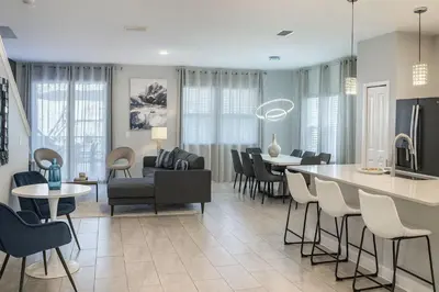 a living room and dining room with a table and chairs at Casa Disney 5 Quartos c/ Piscina – 13 Pessoas in Kissimmee