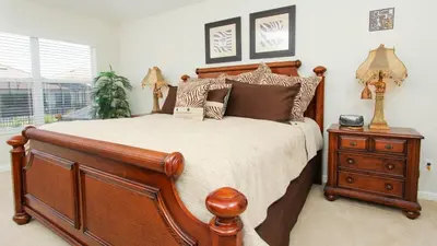 a bedroom with a wooden bed and a night stand at Urban 6 Bed 4 Bath Villa- Perfect stay while exploring Orlando,Florida in Orlando