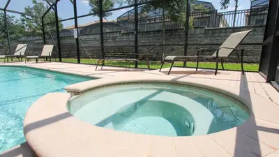 a small swimming pool with two chairs and a fence at Urban 6 Bed 4 Bath Villa- Perfect stay while exploring Orlando,Florida in Orlando
