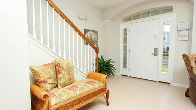 a living room with a chair and a staircase at Urban 6 Bed 4 Bath Villa- Perfect stay while exploring Orlando,Florida in Orlando