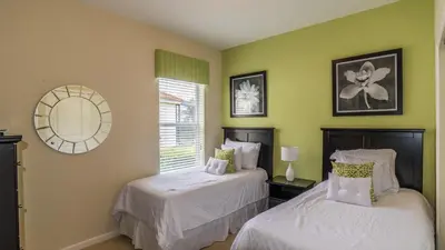 two beds in a room with green walls at Urban 4 Bed 4 Bath Villa- Perfect stay while exploring Orlando,Florida in Orlando