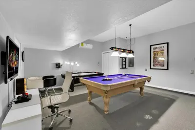 a room with a pool table and two chairs at Urban 6 Bed 4 Bath Villa- Perfect stay while exploring Orlando,Florida in Orlando