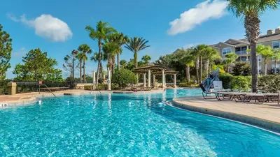 a pool at a resort with palm trees and a gazebo at Urban 6 Bed 4 Bath Villa- Perfect stay while exploring Orlando,Florida in Orlando