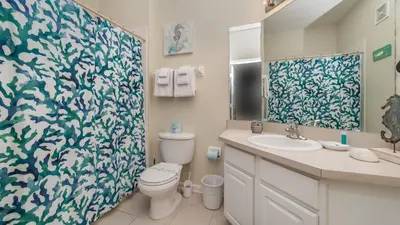a bathroom with a toilet and a sink and a shower at Urban 3 Bed 2 Bath Condo- Perfect stay while exploring Orlando,Florida in Orlando