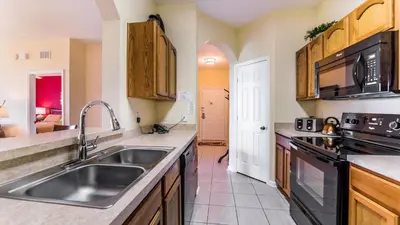 a kitchen with a sink and a stove at Private 3 Bed 2 Bath House - Cozy family vacation home sleeps up to 6 guests in Orlando