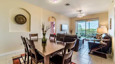 a dining room and living room with a table and chairs at Private 3 Bed 2 Bath House - Cozy family vacation home sleeps up to 6 guests in Orlando