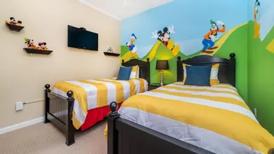 a childs bedroom with two beds and a tv at Contemporary 3 Bed 2 Bath Condo- Near Walt Disney World W/ great amenities in Orlando