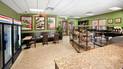 a store with green walls and tables and chairs at Private 4 Bed 3 Bath Townhome - Cozy family vacation home sleeps up to 10 guests in Kissimmee