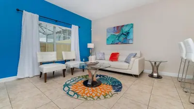 a living room with a couch and a table at Private 4 Bed 3 Bath Townhome - Cozy family vacation home sleeps up to 10 guests in Kissimmee
