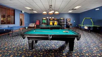 a room with two pool tables and arcade games at Private 4 Bed 3 Bath Townhome - Cozy family vacation home sleeps up to 10 guests in Kissimmee