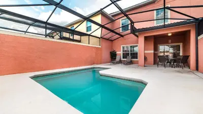 a swimming pool in a house with a patio at Contemporary 4 Bed 3 Bath Townhome - Near Walt Disney World W/ great amenities in Kissimmee