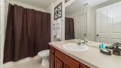 a bathroom with a sink and a toilet at Urban 5 Bed 5 Bath Villa - Perfect stay while exploring Orlando,Florida in Orlando