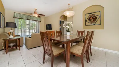 a dining room and living room with a table and chairs at GRH9185 - Windsor Hills Resort - 3 Bed 2 Baths Condo in Orlando
