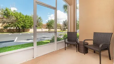 two chairs on a balcony with a view of a street at GRH9185 - Windsor Hills Resort - 3 Bed 2 Baths Condo in Orlando