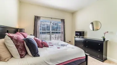 a bedroom with a bed with pillows and a window at GRH9244 - Storey Lake Resort - 5 Bed 4 Baths Townhome in Kissimmee
