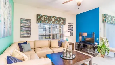 a living room with a couch and a tv at GRH9245 - Storey Lake Resort - 4 Bed 3 Baths Townhome in Kissimmee