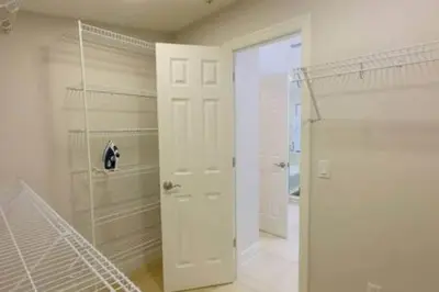 a white bathroom with a shower and a glass door at Perfect Summer Escape - Townhome by Disney in Orlando