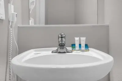a white sink in a bathroom with a mirror at Perfect Summer Escape - Townhome by Disney in Orlando