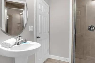 a bathroom with a sink and a mirror and a shower at Perfect Summer Escape - Townhome by Disney in Orlando