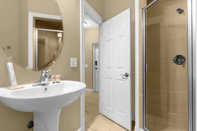 a white bathroom with a sink and a shower at Florida Summer - Townhome 5 min from Disney in Orlando