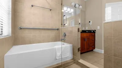 a bathroom with a shower and a bath tub at Sunny Summer Deals - Renovated TownHome by Disney in Orlando