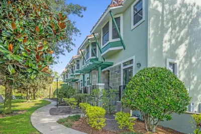 a row of houses with trees in front at Sunny Summer Deals - Renovated TownHome by Disney in Orlando