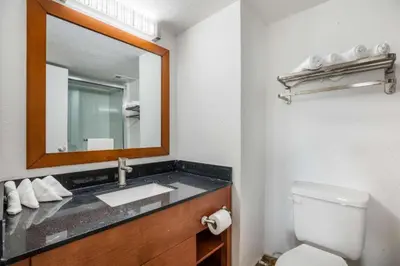 a bathroom with a sink and a mirror at Hotel O Orlando Airport near Florida Mall in Orlando