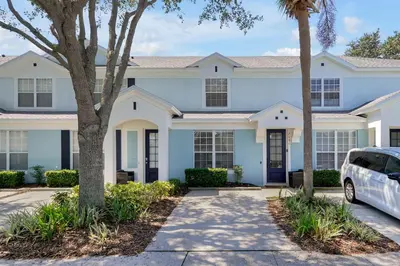 a white house with a car parked in front of it at Windsor Hills Resort - Water Park - Private Heated Plunge Pool - Near Disney in Orlando