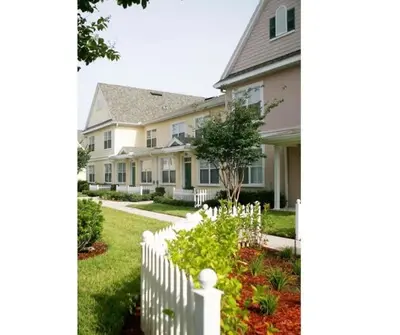 a white picket fence in front of a house at Townhome Near Disney Mid Term rentals Welcome in Kissimmee