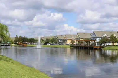 a view of a lake with houses and a dock at Townhome Near Disney Mid Term rentals Welcome in Kissimmee
