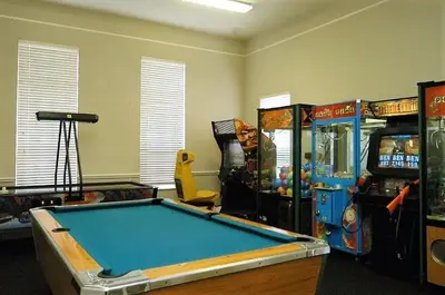a room with a pool table and arcade games at Townhome Near Disney Mid Term rentals Welcome in Kissimmee