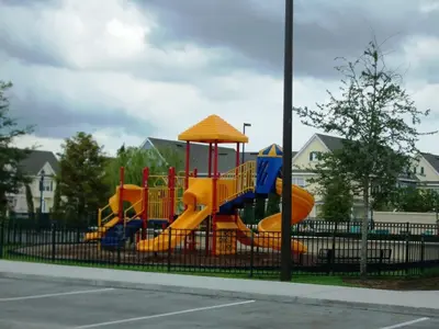 a playground with a slide in a park at Townhome Near Disney Mid Term rentals Welcome in Kissimmee